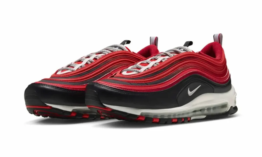 Pair of red and black Nike sneakers with layered uppers and visible transparent air cushions on a white background
