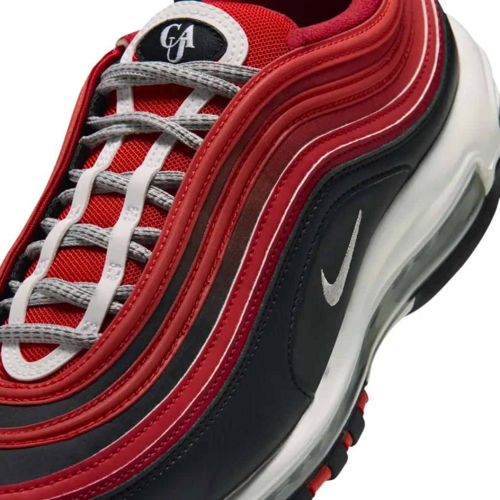 Close-up of a red, black, and white Nike sneaker with gray laces and a visible swoosh logo