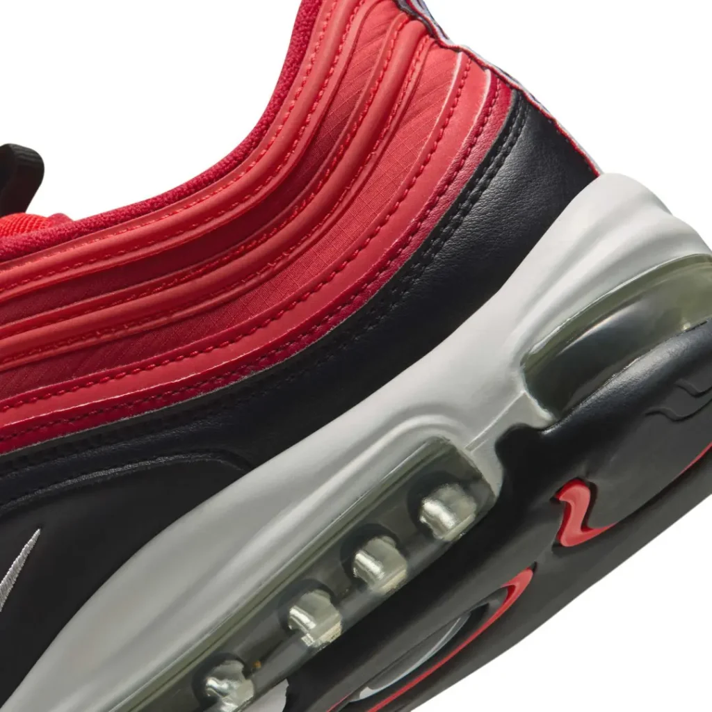 Close-up of a red and black sneaker with a visible air-cushioned sole and gray midsole
