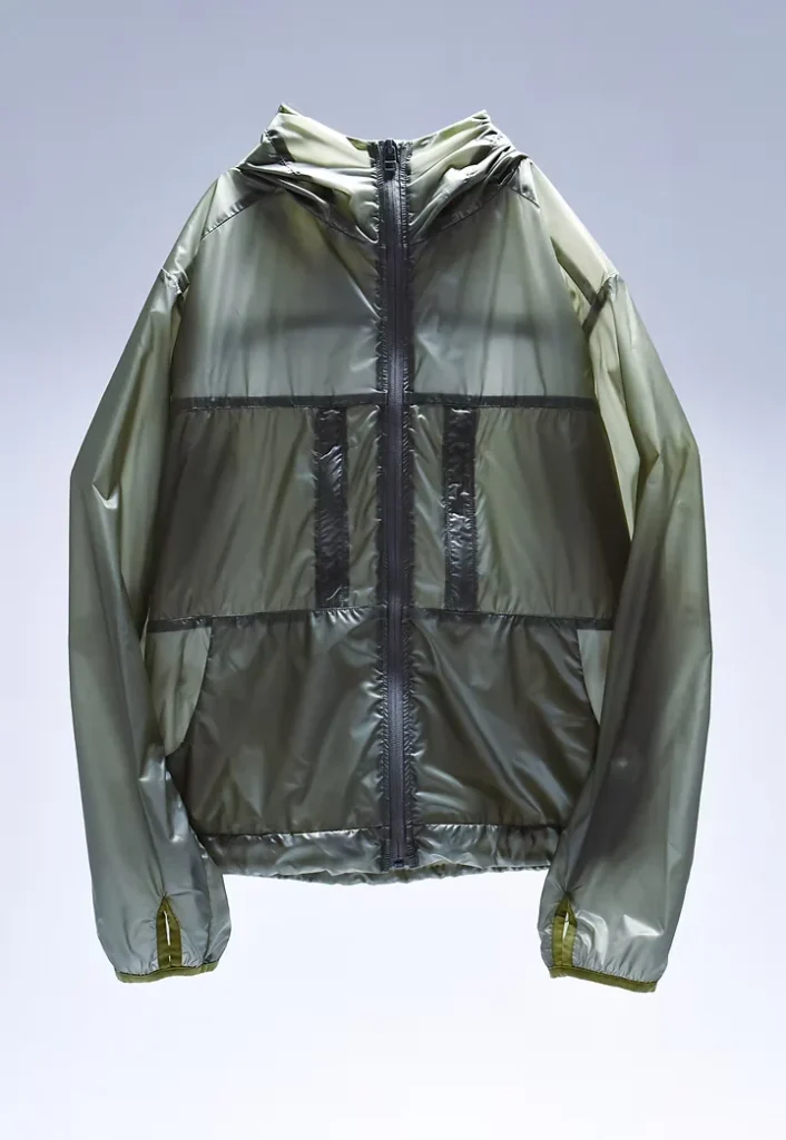Olive green hooded jacket with a glossy lightweight shell, black zipper and horizontal panel seams, shown against a pale