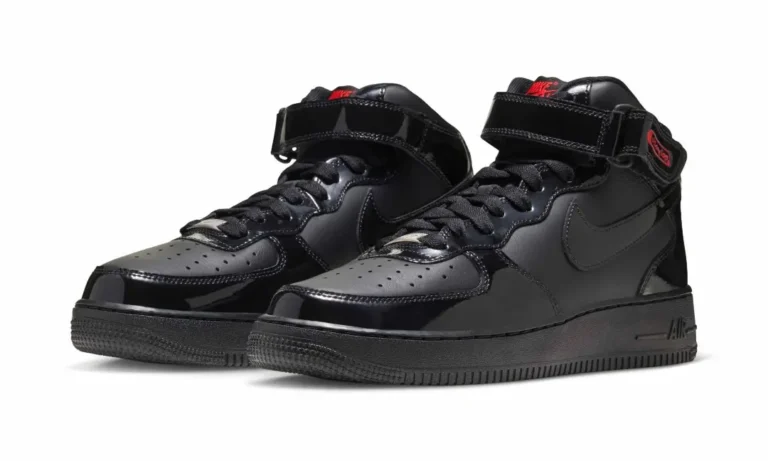 Pair of black patent Nike Air Force 1 Mid sneakers with ankle straps, black swooshes and red branding on a white background