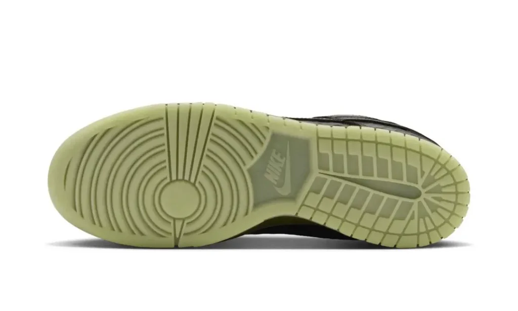 Light green Nike sneaker outsole with circular and grid-patterned tread, shown against a white background