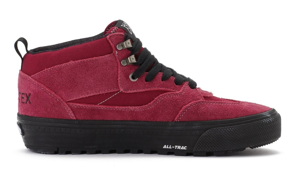 Burgundy suede high-top shoe with black laces, metal eyelets and a thick black lugged sole on white background