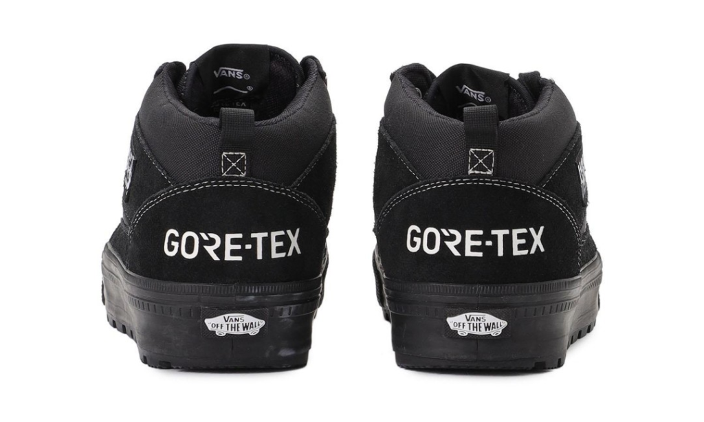 Pair of black Vans high-top shoes viewed from the rear, with white GORE-TEX branding and rubber soles on a white background