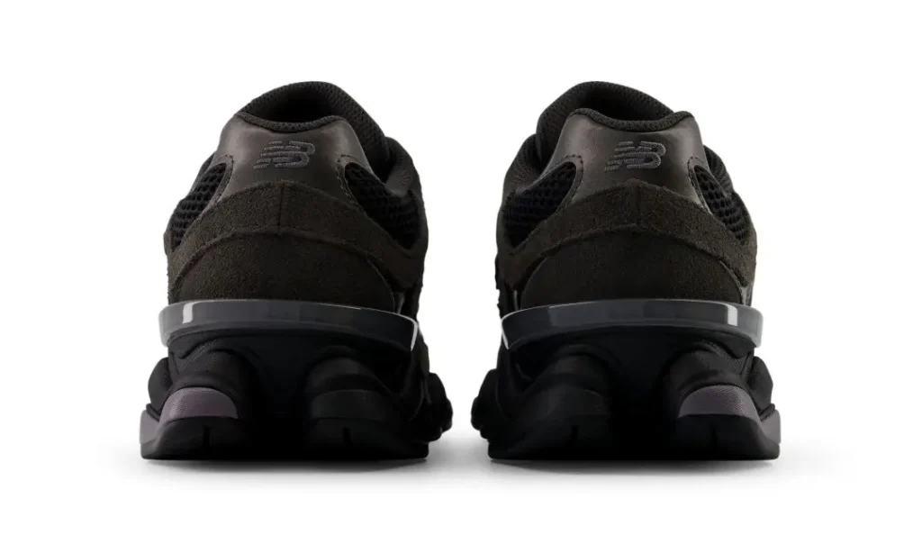 Rear view of black and Neptune grey New Balance 9060 sneakers side by side on a white background