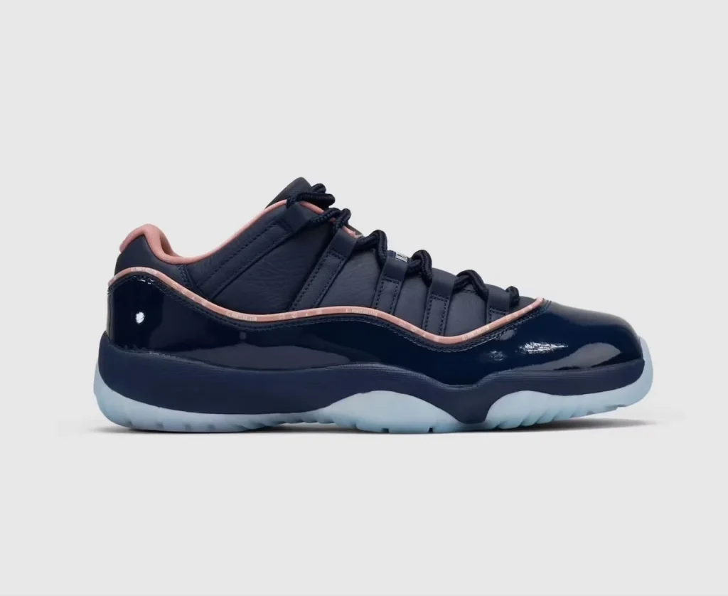 Navy and pink low-top sneaker with glossy panels, black laces, and a translucent icy sole on a light background