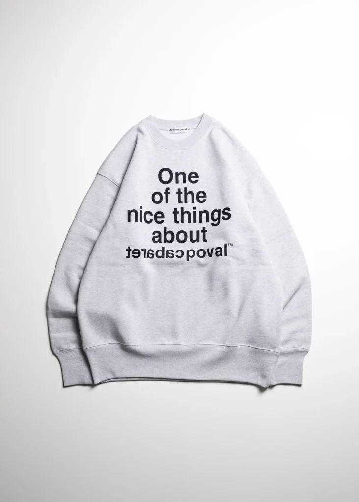 Light gray crewneck sweatshirt laid flat, with black text reading “One of the nice things about lovadopovai”