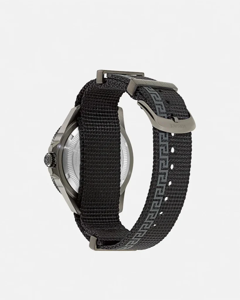 Versace watch with a black woven strap, silver case and Greek Key buckle, shown against a white background