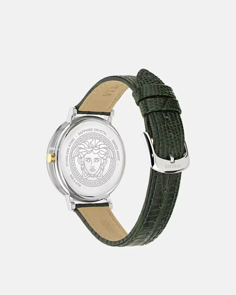Silver Versace wristwatch with Medusa caseback, tan leather lining, and dark green textured strap against a light background