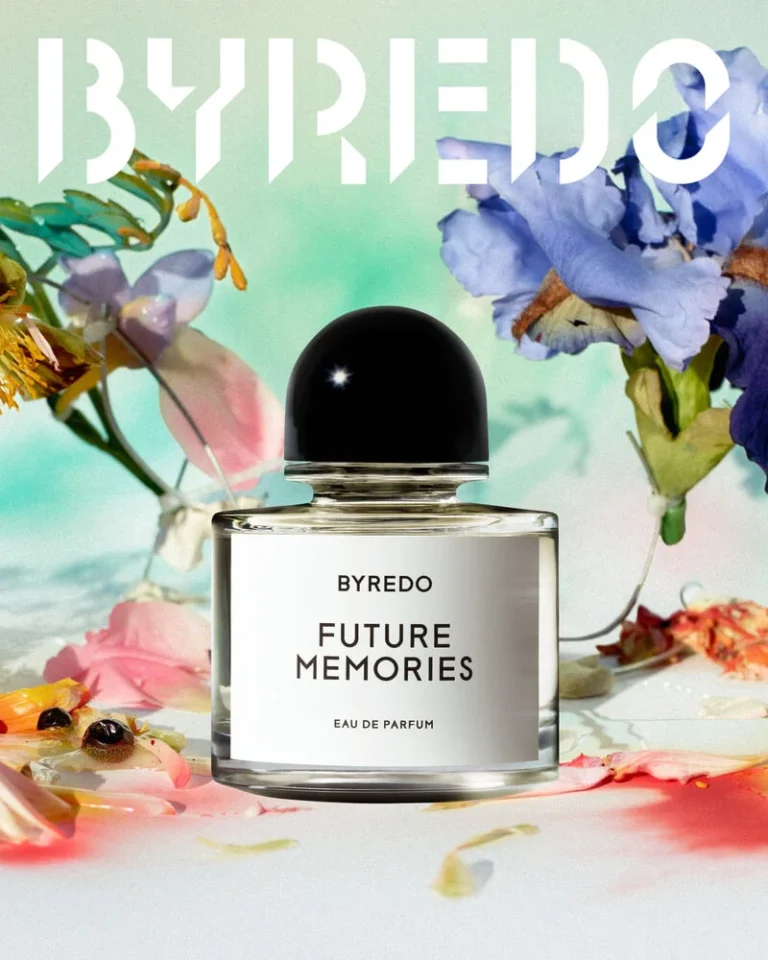 BYREDO Future Memories perfume bottle with black cap, surrounded by colorful flowers and petals on a pastel background