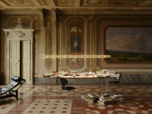 Linear pendant light with glowing spheres hangs above a book-covered table in an ornate historic room