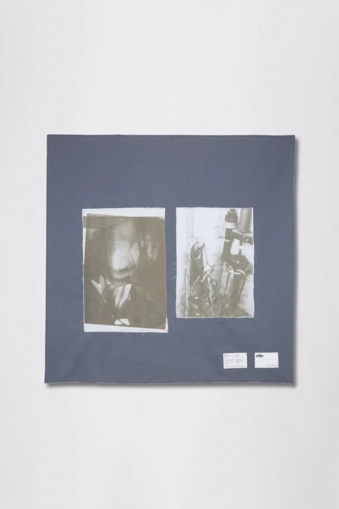 Dark square textile with two monochrome photo panels and two small white labels near the bottom right
