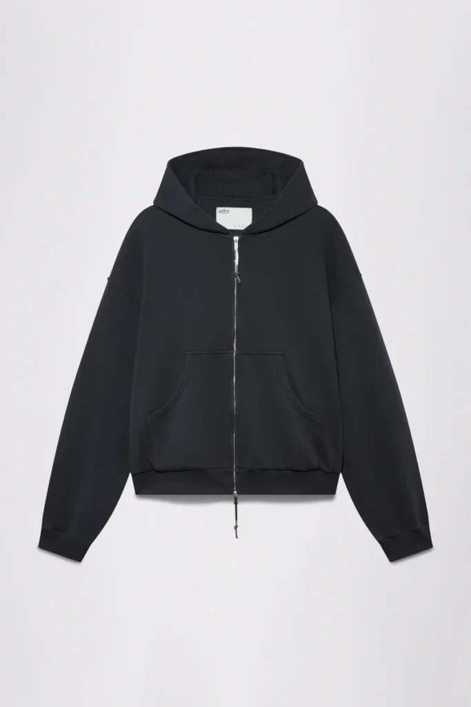 Black zip-up hoodie with drawstring hood, kangaroo pocket and long sleeves, displayed against a white background