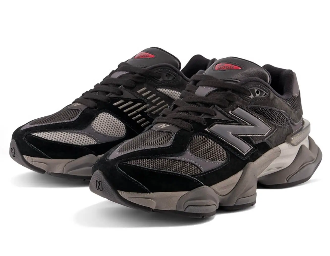 Pair of black and Neptune grey New Balance 9060 sho with mesh panels, layered soles and red tongue labels on white