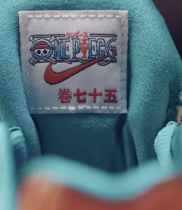 Close-up of a Nike One Piece label stitched onto turquoise fabric, with Japanese characters beneath the logo