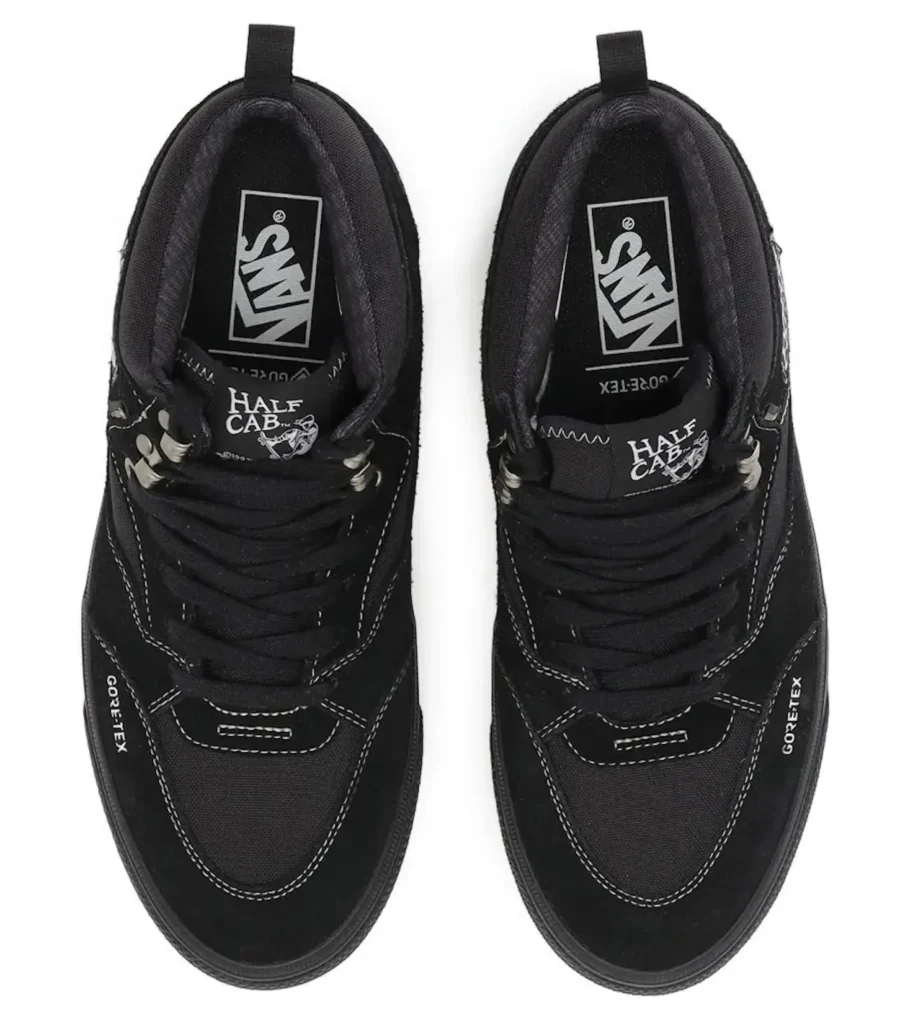 Pair of black Nike shoe with white stitching, Gore-Tex labels, and Half Cab tongue branding on a white background