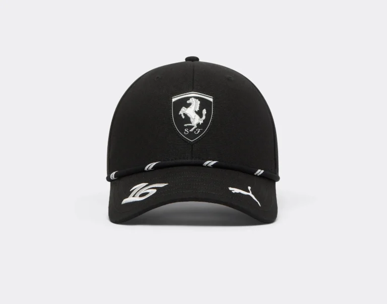 Black Ferrari cap with a silver prancing-horse shield, white Puma logo and white stripes on a plain light background