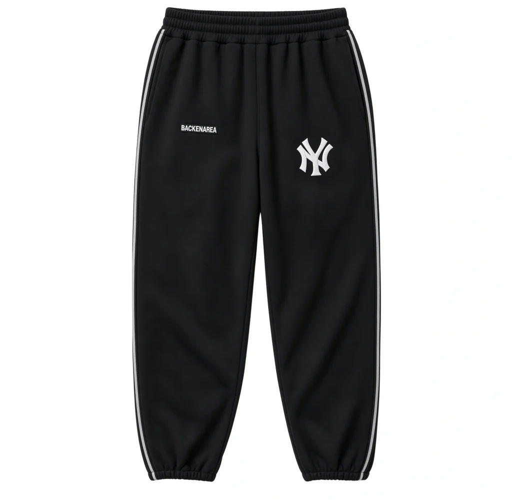 Black Yankees sweatpants with white side stripes, elastic cuffs and waistband, displayed against a white background