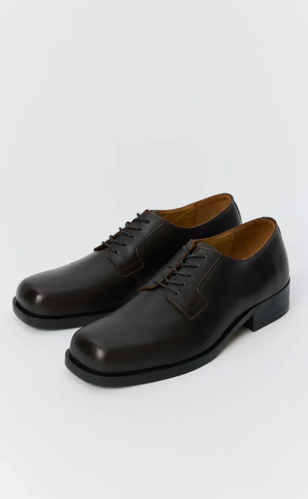 Pair of black leather lace-up dress shoes with rounded toes and low block heels on a white background