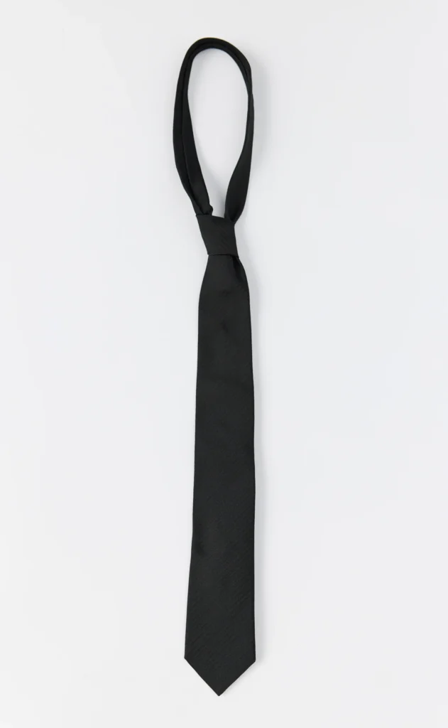 Black necktie with a narrow looped neck and pointed tip on a white background