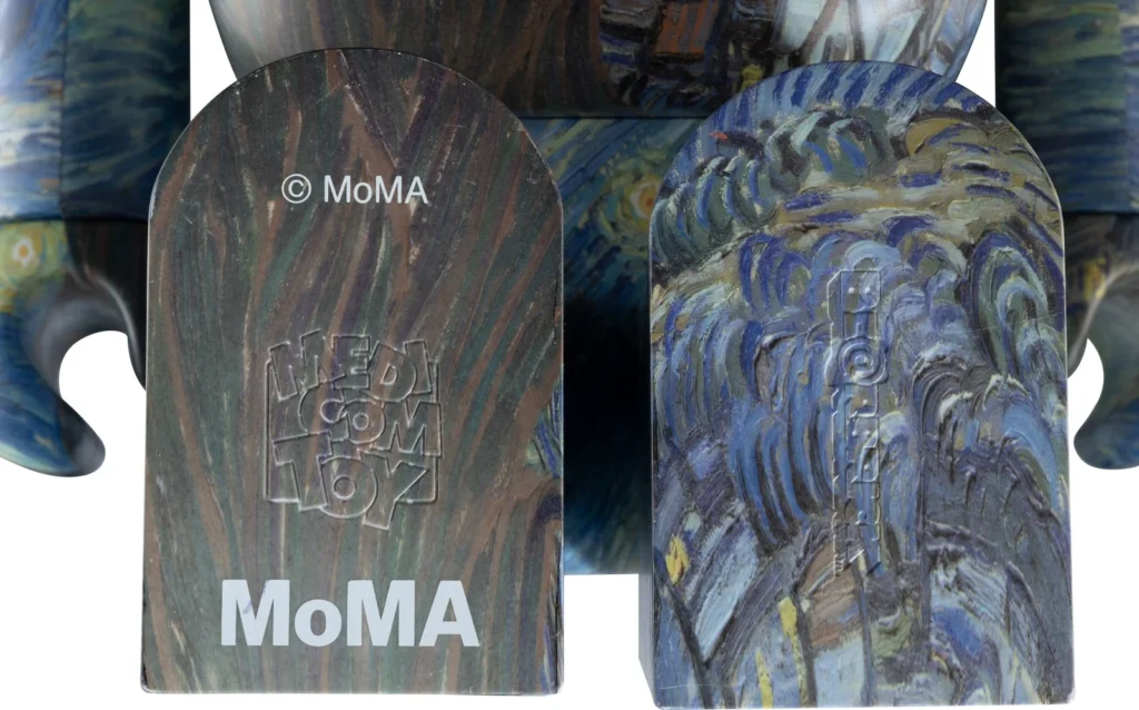 Two decorated skateboard decks displayed side by side, one brown and one blue, with MoMA logos overlaid