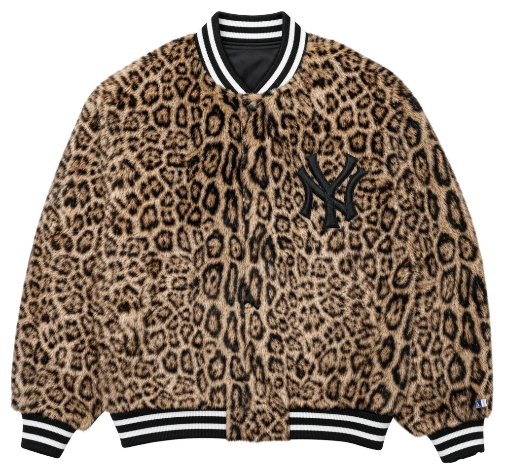 Leopard-print Yankees baseball jacket with black-and-white striped ribbing, shown flat against a white background