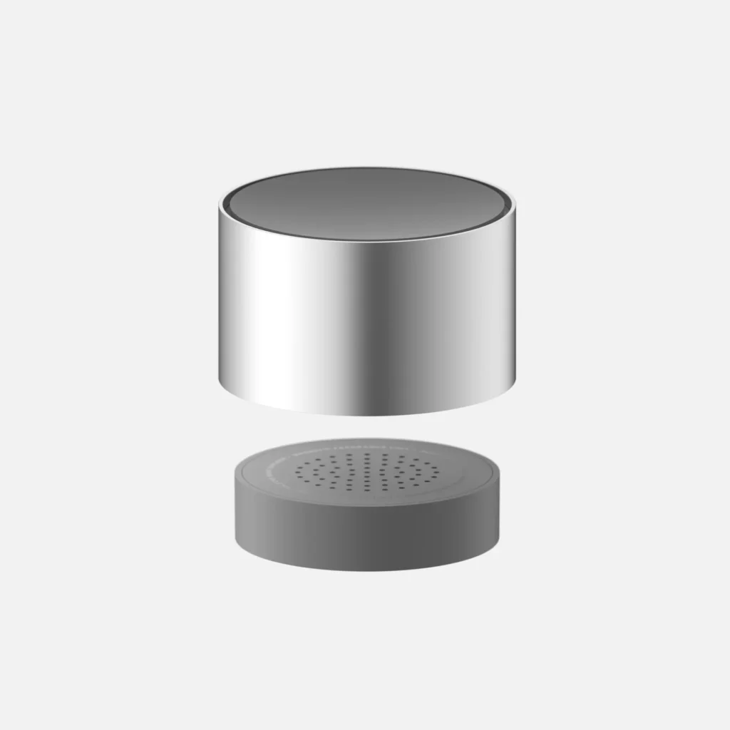 Disassembled cylindrical car diffuser with a silver upper housing and gray perforated lower base on a white background