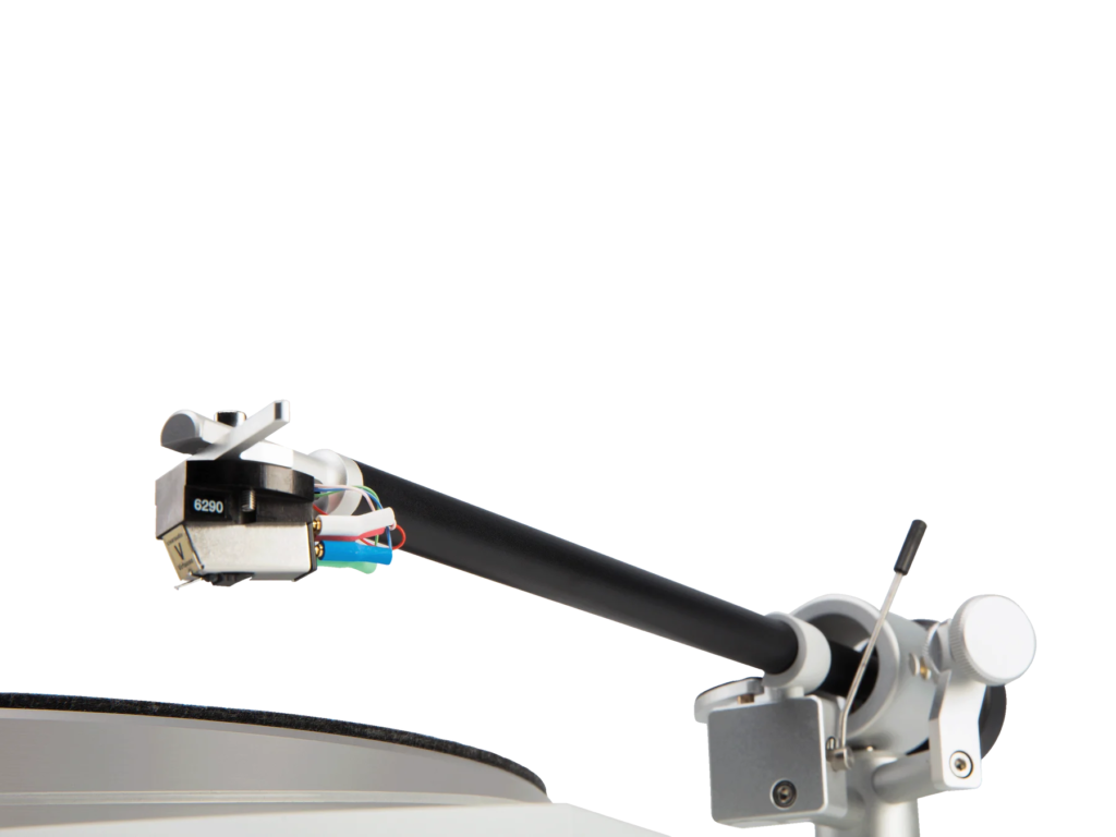 Close-up of a black tonearm and exposed cartridge wiring on a white turntable against a white background