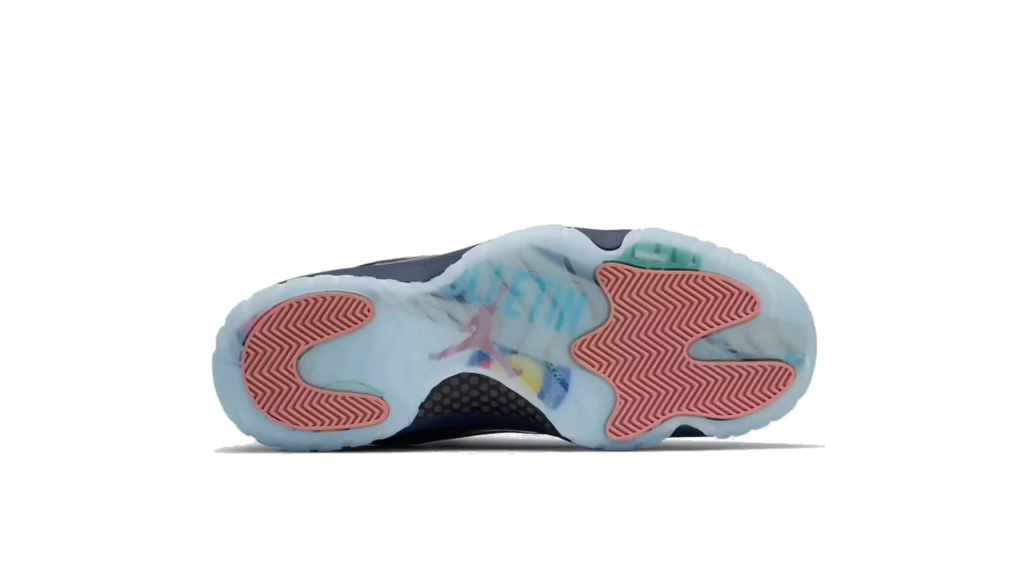 Bottom view of a translucent pale blue shoe with pink zigzag traction sections and multicolored accents on white
