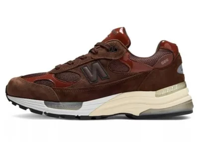 Brown New Balance 992 shoe with mesh and suede panels, cream midsole, and gray outsole on a white background