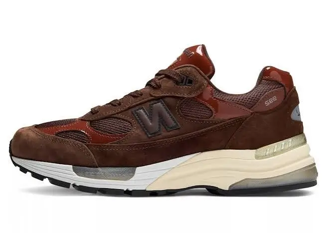 Brown New Balance 992 shoe with mesh and suede panels, cream midsole, and gray outsole on a white background