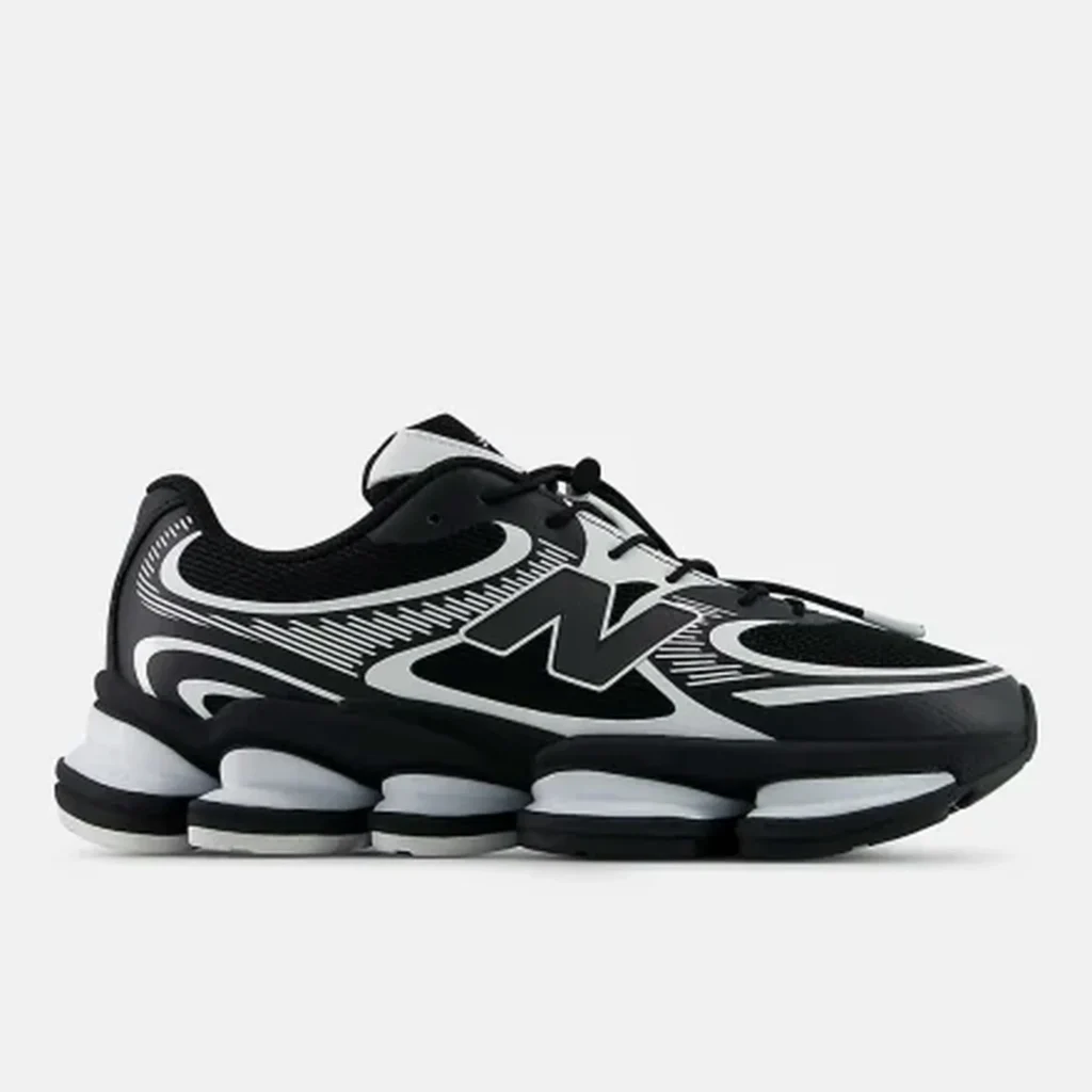 Pair of black-and-white New Balance shoe with bold N logos and segmented white soles on a light background