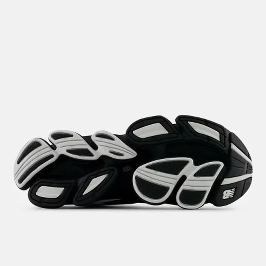 Black-and-white New Balance sneaker with layered mesh panels and sculpted, segmented sole on a white background