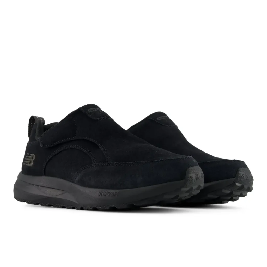 Pair of black New Balance slip-on shoes with thick soles, shown against a white background