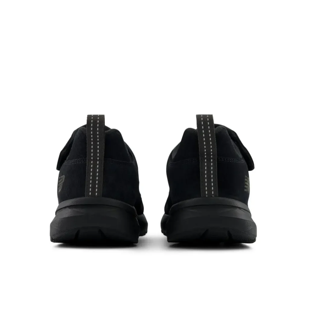 Pair of black sneakers shown from the rear, with reflective vertical heel pull tabs and chunky soles on a white background