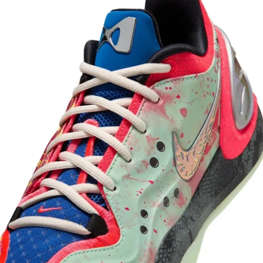 Close-up of a multicolor Nike basketball shoe with cream laces, mint-and-pink splattered panels, blue tongue, and black sole